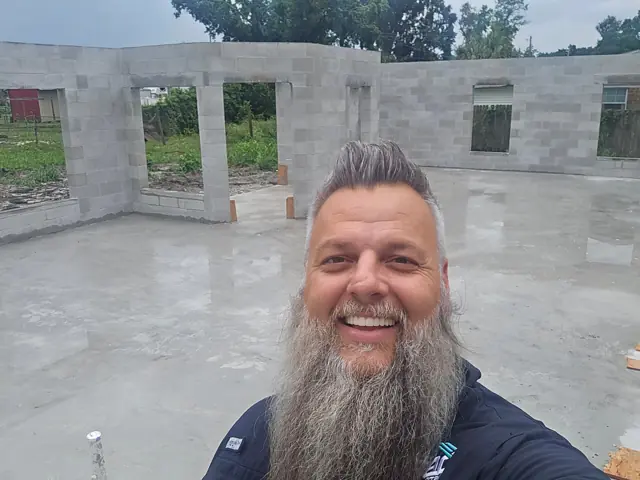Shaun Irwin, owner of Everyday Properties, on a jobsite with block walls up